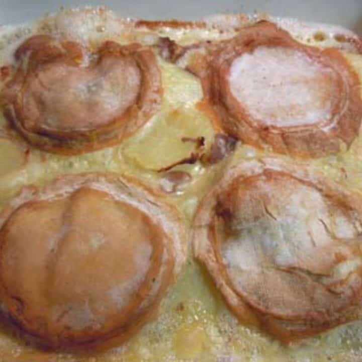 A light brown and yellow dish of cheese, potato, cream, and white wine.