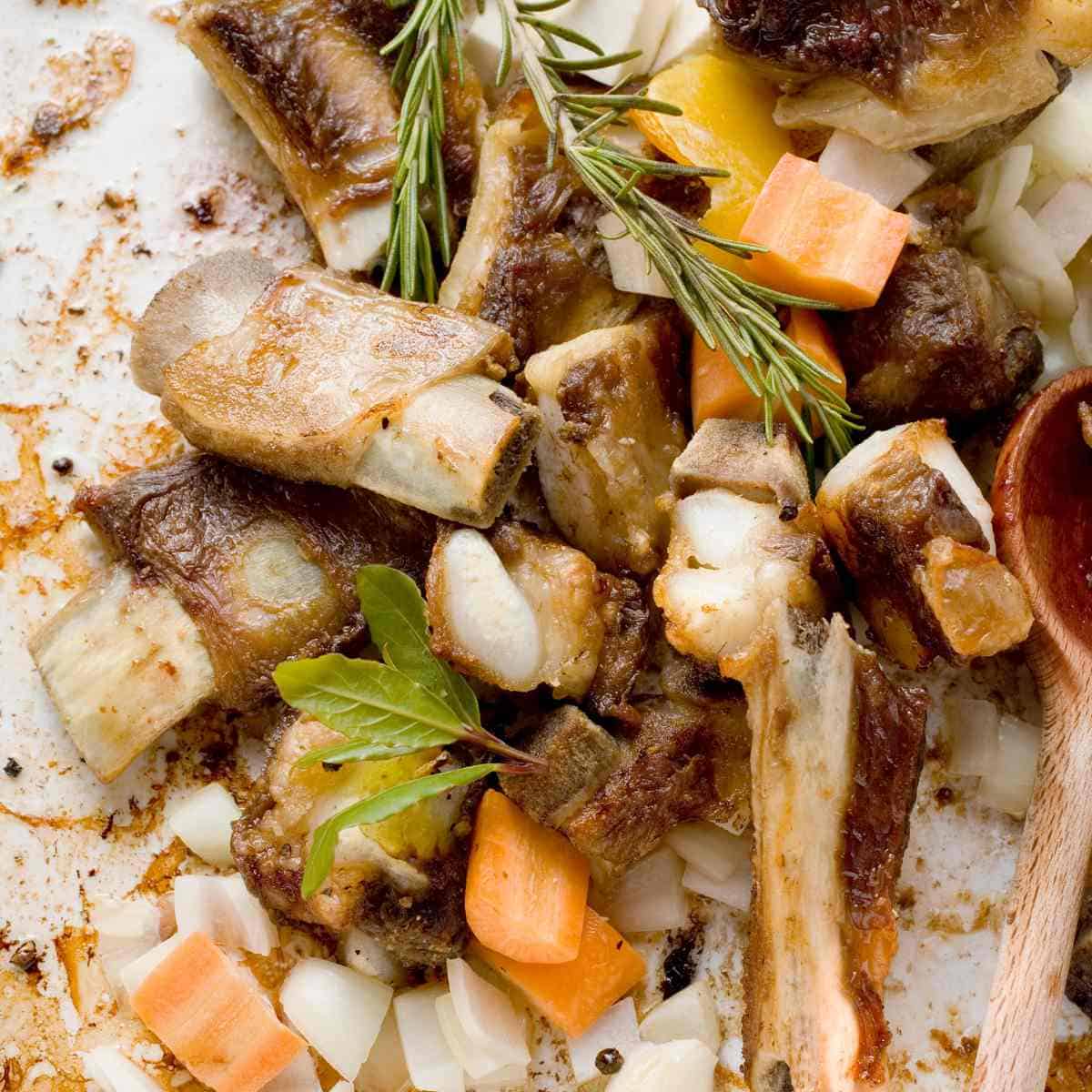 Veal bones with bits, carrots, onions, and herbs.