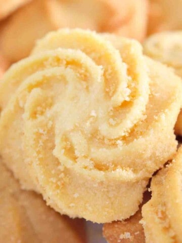 White swirl shaped cookies, sprinkled with sugar.