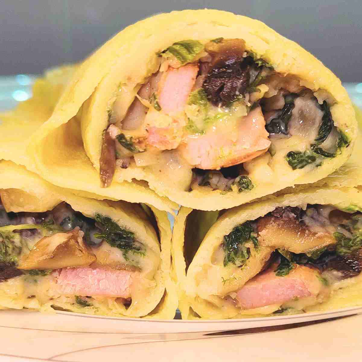 Three half crepes that have been cut and placed on top of one another.