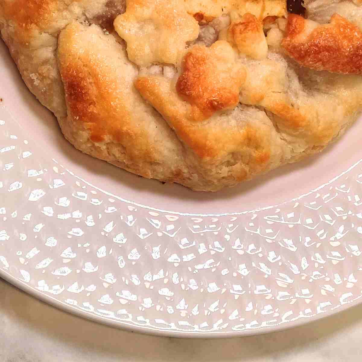 Golden brown galette on a white plate.