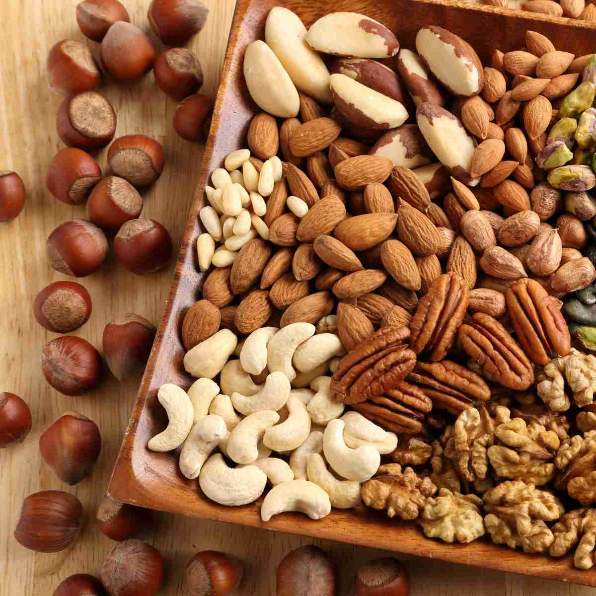 An assortment of nuts and seeds that are white, cream, red, and all shades of brown.