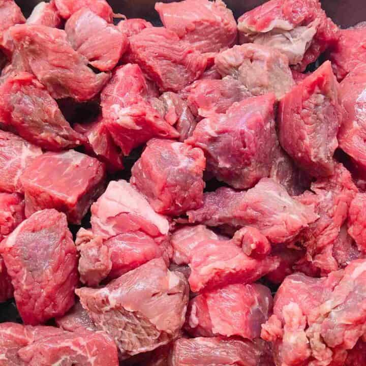 Raw red chunks of beef for stew.