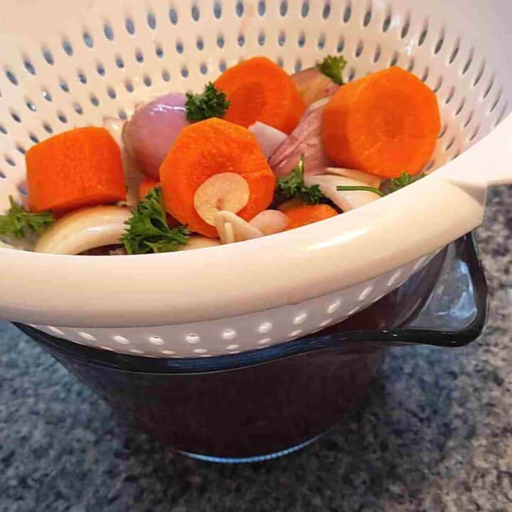 Straining marinade vegetables.