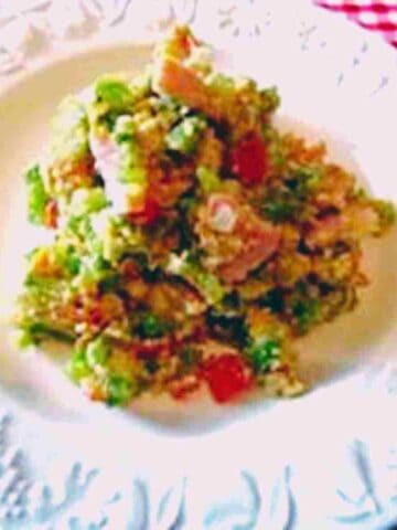 A white plate with a pile of colorful foods.