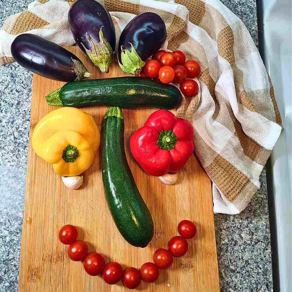 The colorful vegetables in ratatouille arranged to look like a face.