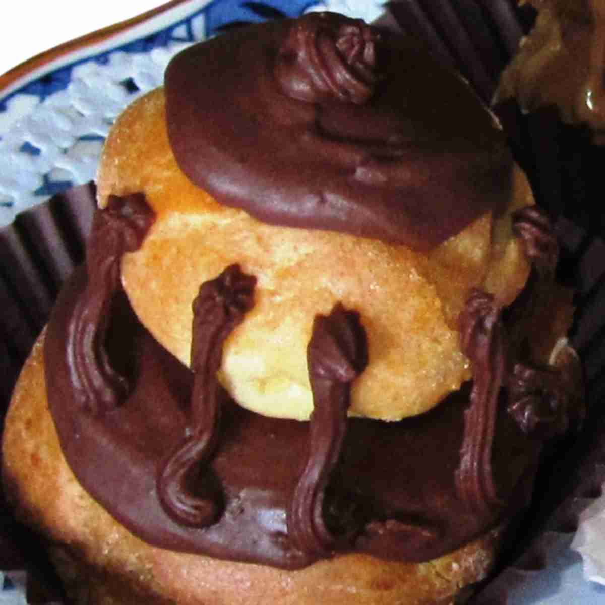 A cream puff topped with chocolate buttercream frosting.