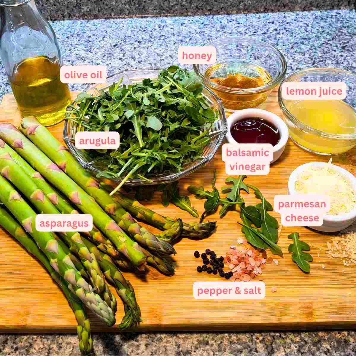 Labelled ingredient photo roasted asparagus, arugula salad with lemon balsamic vinaigrette.