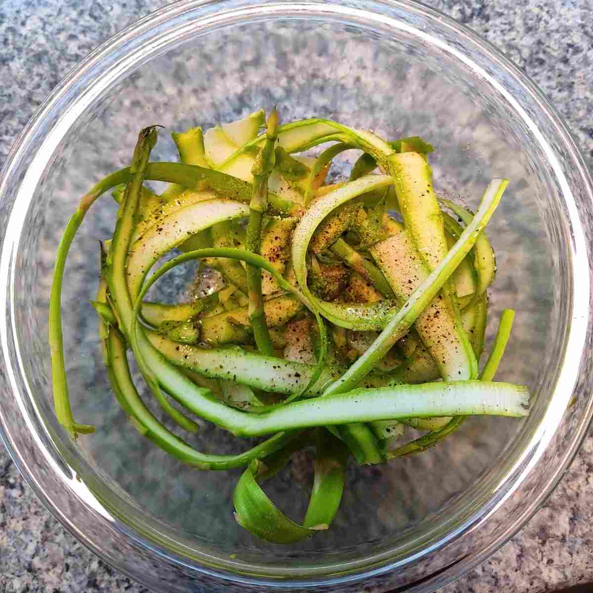 Shaved asparagus tossed with olive oil and seasoning.
