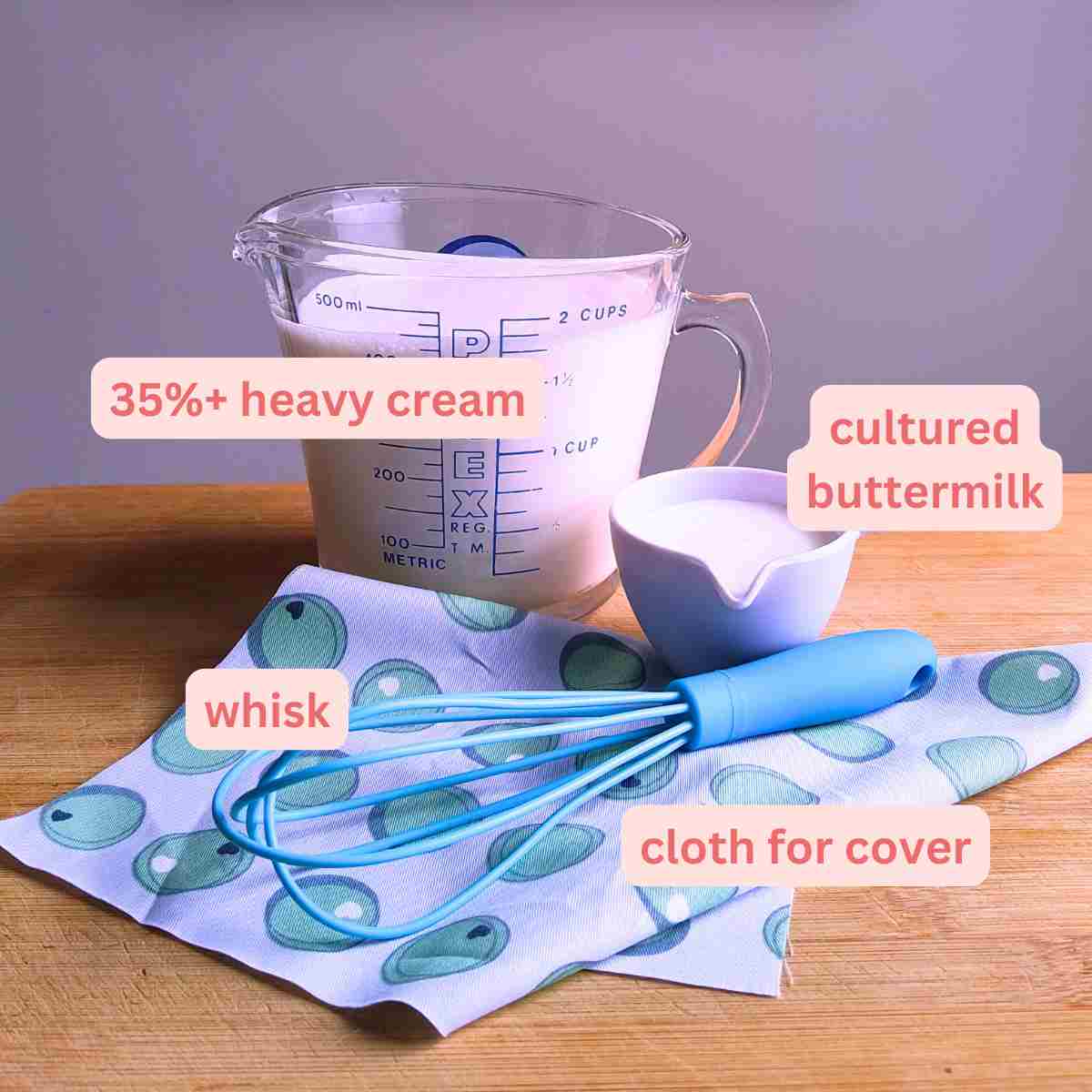 A labelled photo of the ingredients and tools needed to make homemade creme fraiche.