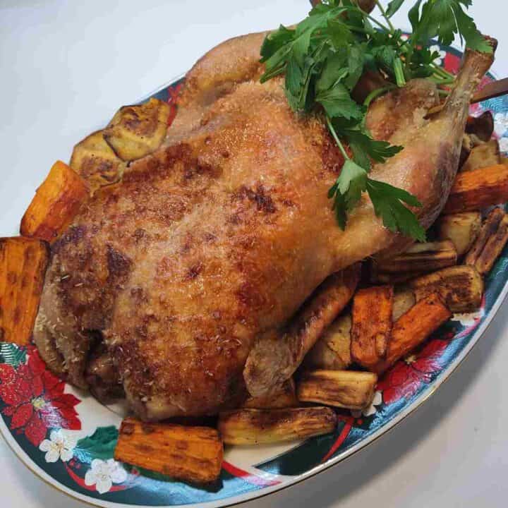 Roast duck in the oven with roasted vegetables.