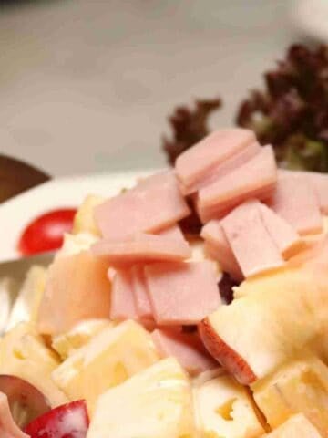A classic French Salade Auvergnate with potatoes, ham, cheese, and lettuce.