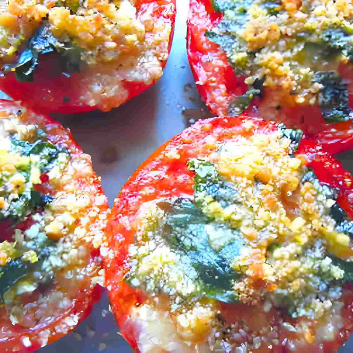Photo of quick and easy oven roasted tomatoes sprinkled with herbs and cheese.