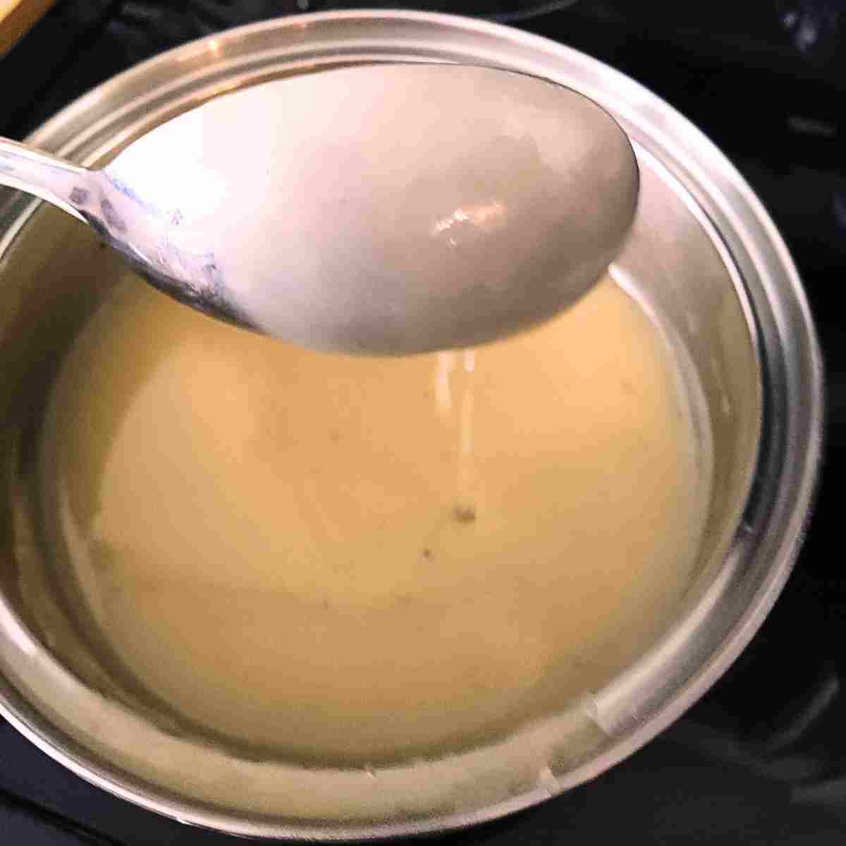 The sauce is finished cooking when it coats the back of the spoon.