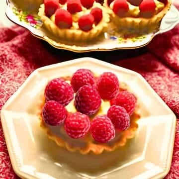 French raspberry and pastry cream filled tarts for a French dessert.
