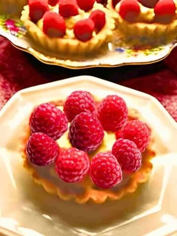 French raspberry and pastry cream filled tarts for a French dessert.