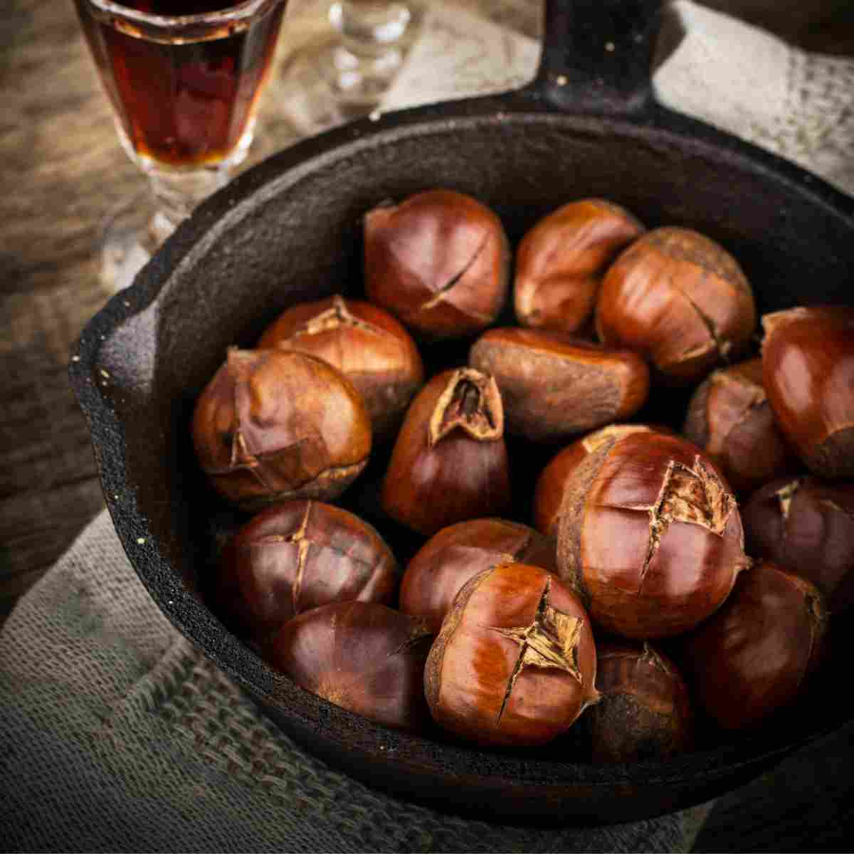Chestnuts roasted on the stove top in cast-iron pan.