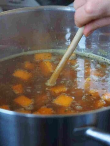 A pot on the stove full of fresh vegetables to make a useful stock for French recipes.