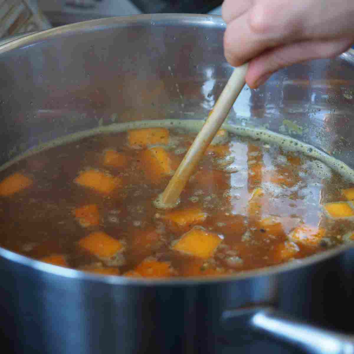 A pot on the stove full of fresh vegetables to make a useful stock for French recipes.