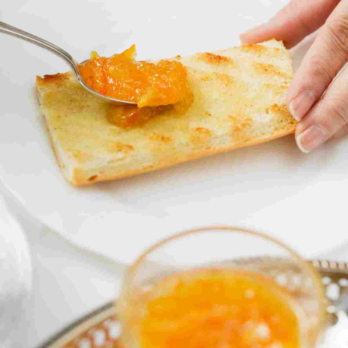 French baguette sliced for breakfast with good butter and preserve.