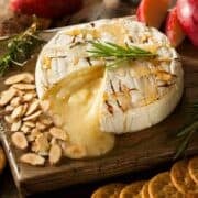 Baked camembert with rosemary, apple slices, toasted almonds, drizzled with honey