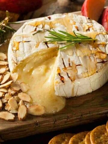 Baked camembert with rosemary, apple slices, toasted almonds, drizzled with honey
