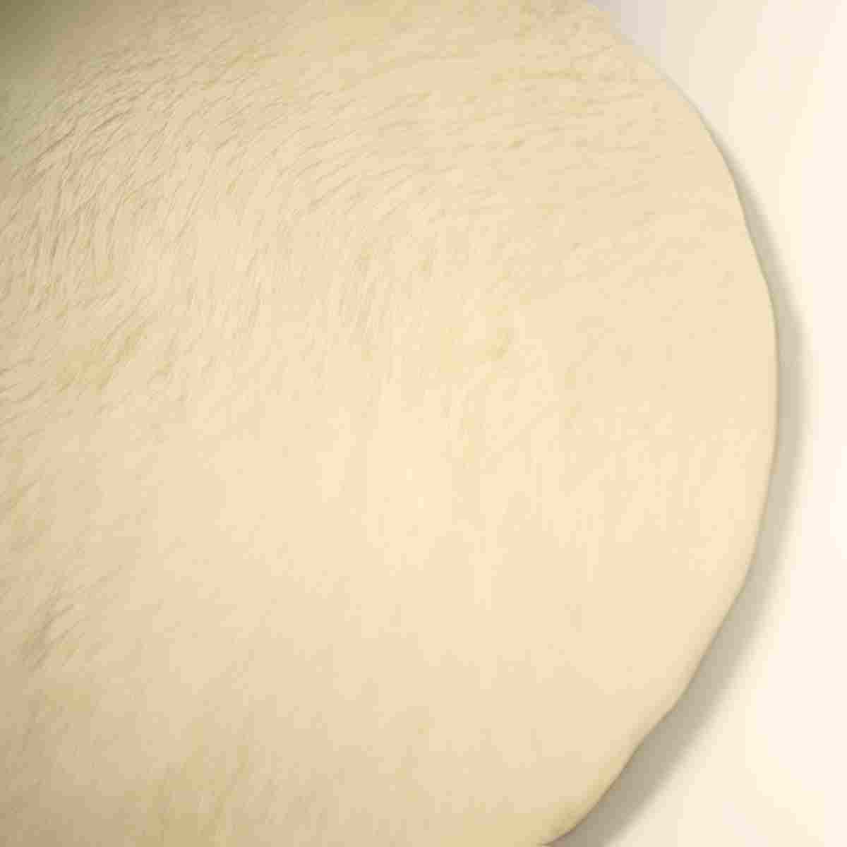 Baguette dough has risen and is now ready to be cut into 3 and shaped.