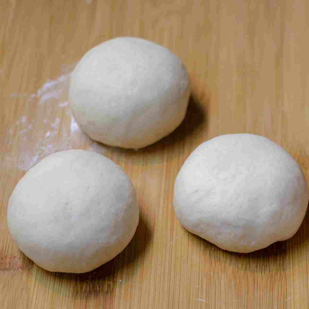 Dough shaped into 3 equal balls before shaping baguette loaves.