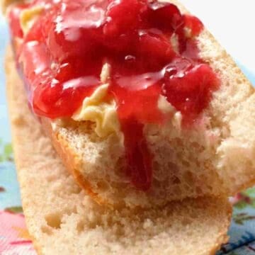 French breakfast baguette sliced horizontally with butter and jam.