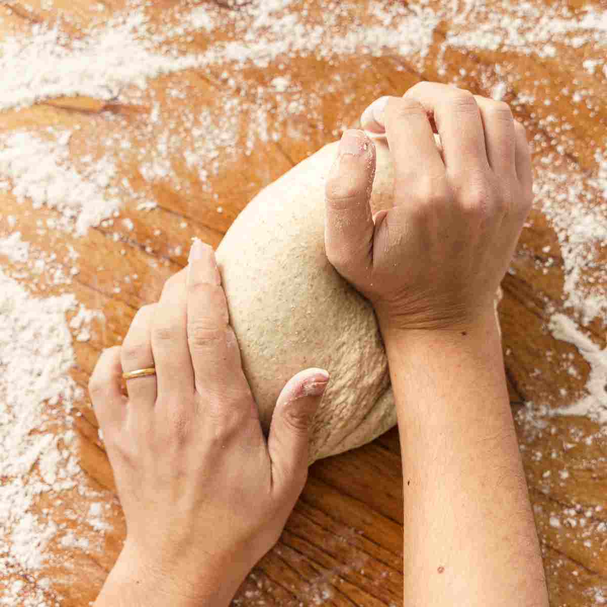 Kneading baguette dough to strengthen gluten in the flour.