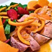 A delicious duck l'orange dinner with sliced orange peel in the luscious sauce on duck meat.