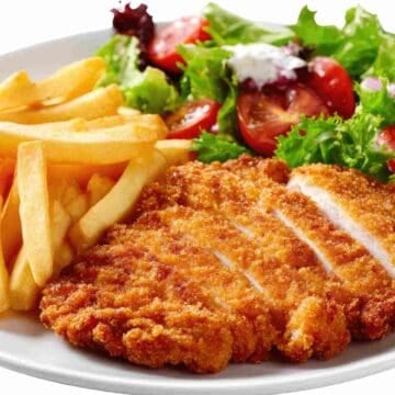 A chicken fillet flattened with a golden bread coating to make it crispy.
