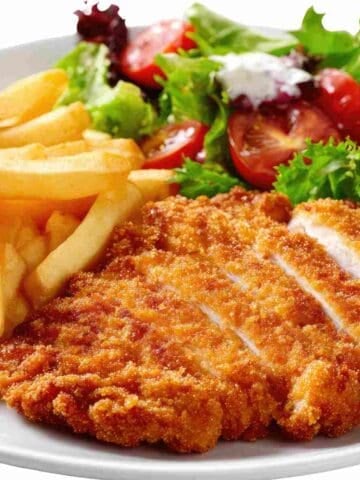 A chicken fillet flattened with a golden bread coating to make it crispy.