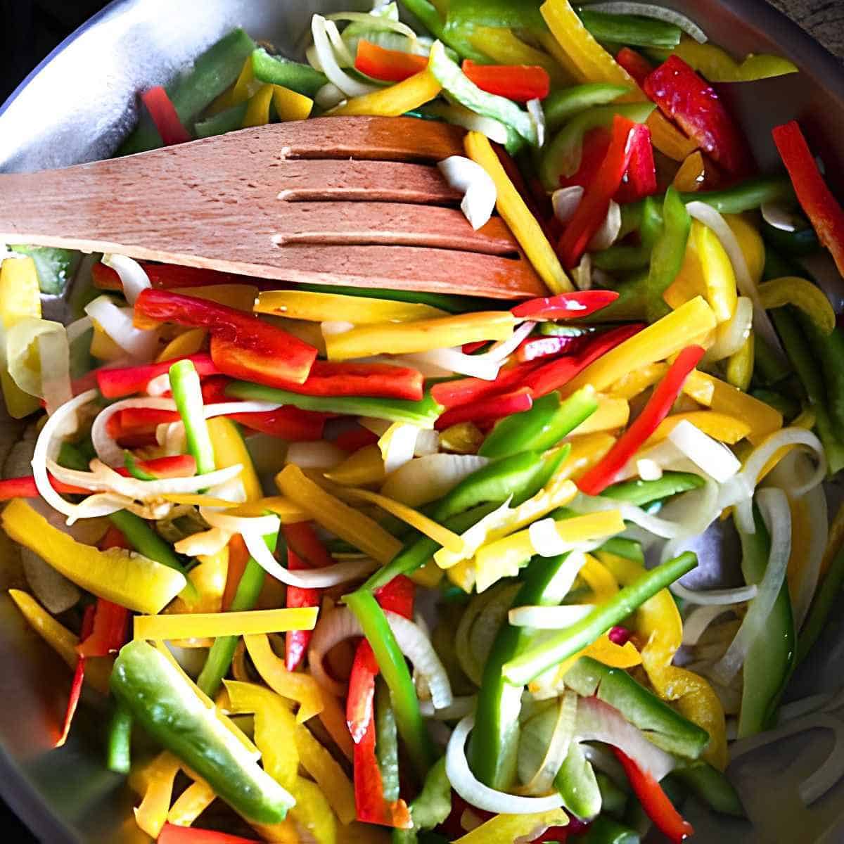 Sauteed colourful sweet bell peppers for a delicous French vegetable recipe.