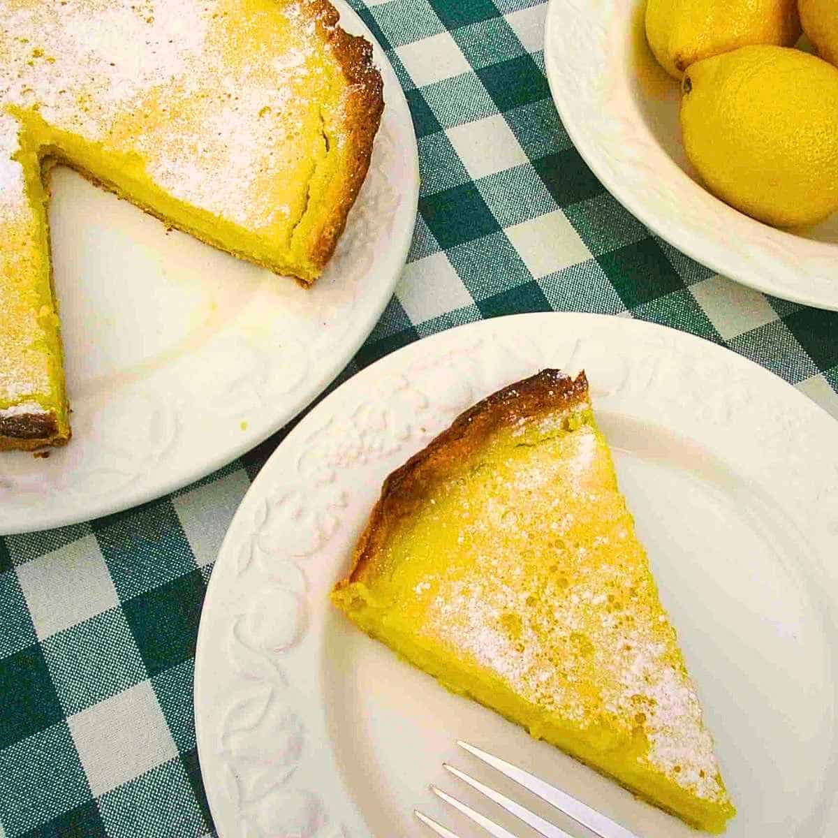 French lemon tart with sweet shortcrust pastry and tangy lemon filling.