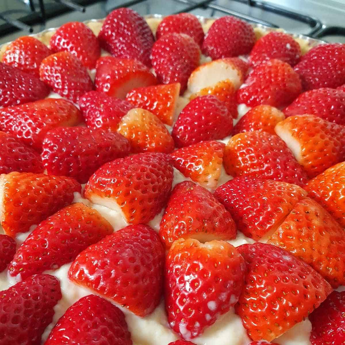 A nine inch strawberry tart with orange cream cheese filling.