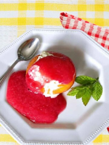 Poached Peach Melba is a French classic dessert with vanilla ice cream and raspberry sauce.